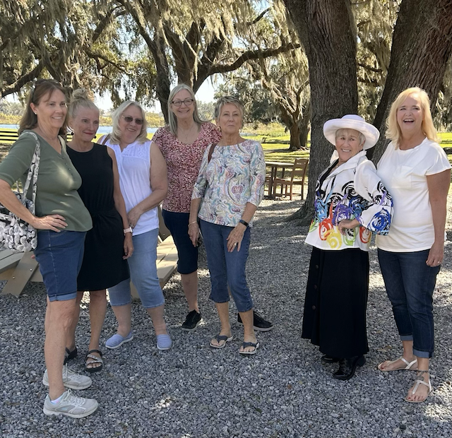 Some MOM2MOM group members posing under a large tree