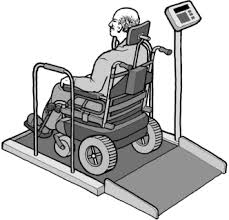 Disabled patient in wheelchair being weighed on an ADA approved scale